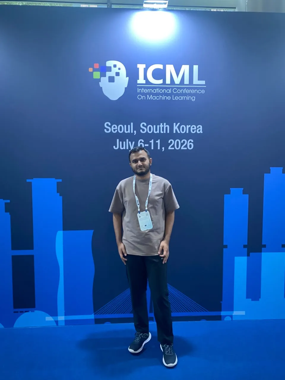 Standing in front of the ICML 2026 Seoul backdrop
